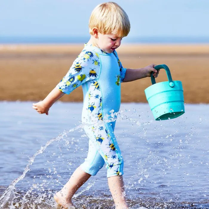 Junge trägt UV Schwimmanzug "Bugs Life" am Strand