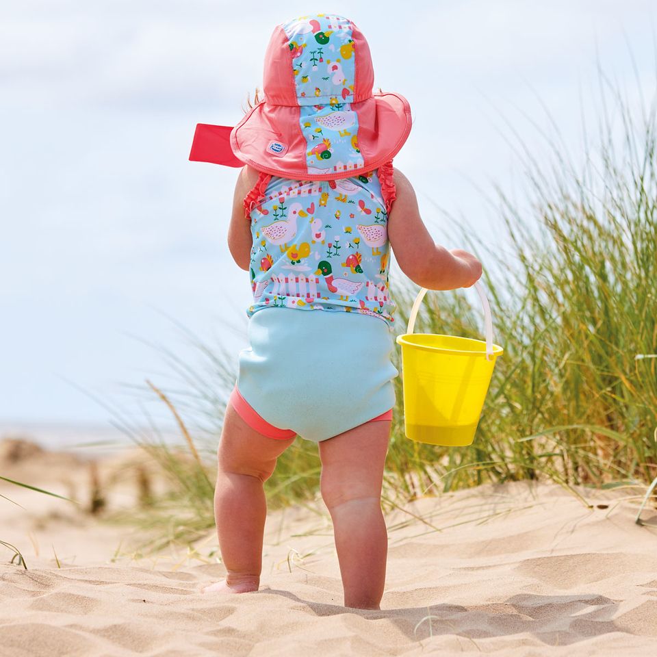 Mädchen am Strand trägt den UV Sonnenhut "Little Ducks" mit Nackenschutz